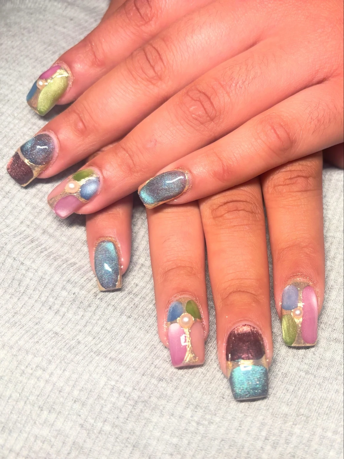 Carlita’s original nail work: multicolor + pearl details