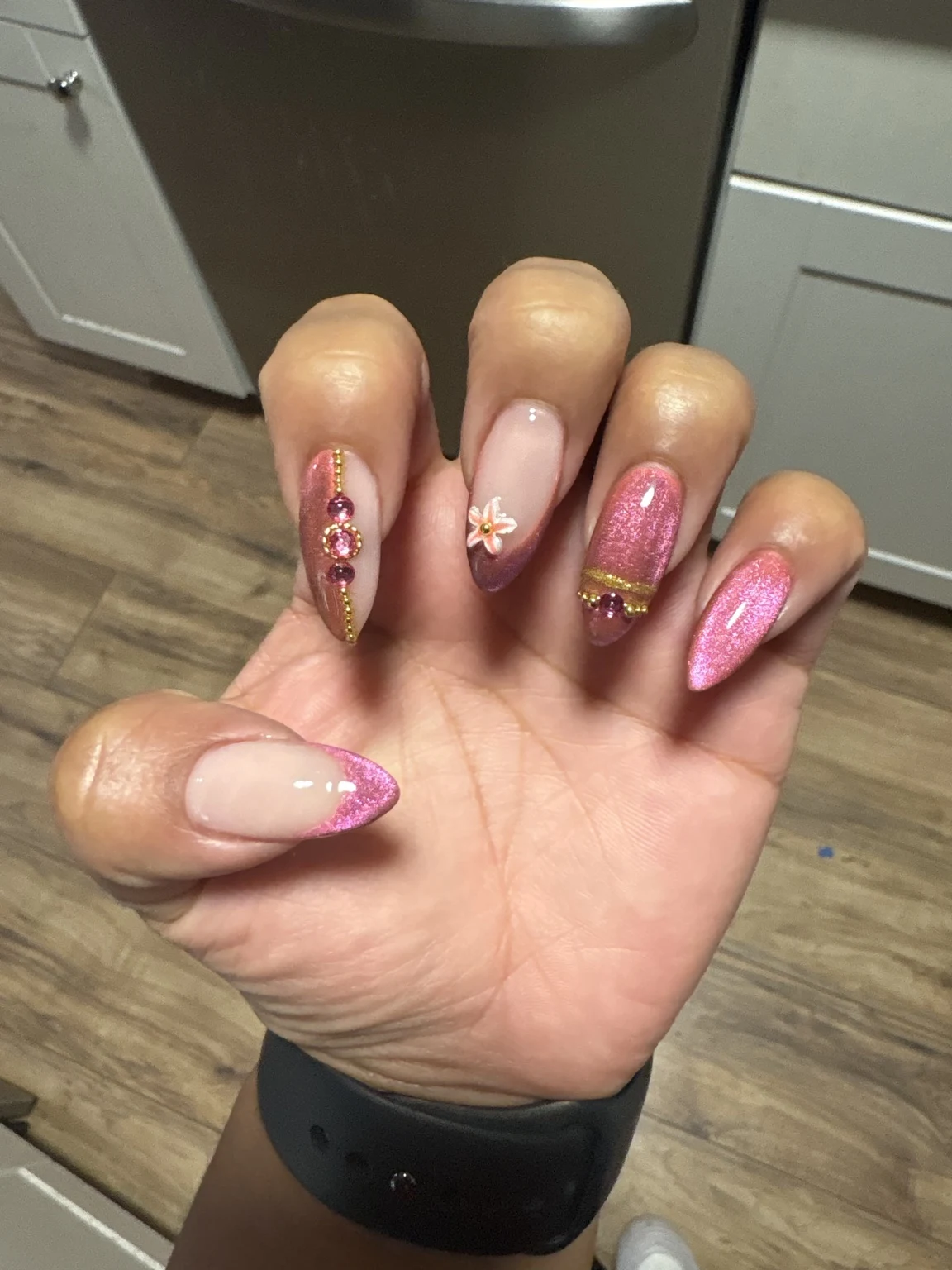 Carlita’s original nail work: pink shimmer + jewels