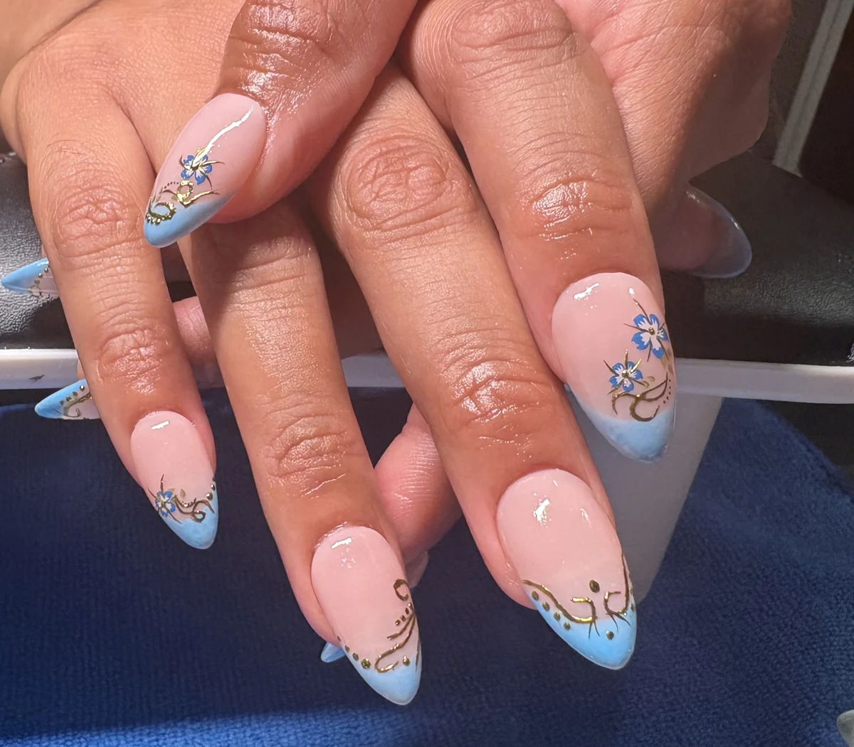 Carlita’s original nail work: blue tips + florals